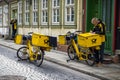 German postman of the Deutsche Post delivering mail using an electric bicycle. Werningrode, Germany - April 26, 2018 Royalty Free Stock Photo