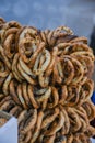 German pretzels stack one over each other, group of thin dry pretzels on rope on display Royalty Free Stock Photo