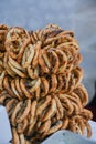 German pretzels stack one over each other, group of thin dry pretzels on rope on display Royalty Free Stock Photo