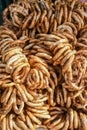 German pretzels stack one over each other, group of thin dry pretzels on rope