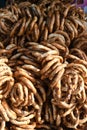 German pretzels stack one over each other, group of thin dry pretzels on rope