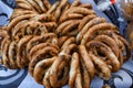 German pretzels stack one over each other, group of thin dry pretzels on rope