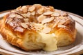 German pudding cream plunder pastry wih almond slices on plate