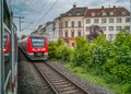 a German regional train seen out of another train with old city houses in the back