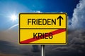German road sign with the german words for Peace and War - Krieg und Frieden in front of blue and grey sky