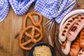 German sausages on the grill. Traditional and pastry brezel for the beer festival. Wood background and decor. View from Royalty Free Stock Photo