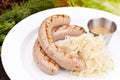 German sausages with sauerkraut on white plate Royalty Free Stock Photo