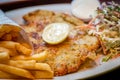 German schnitzel pork chop woth fries apple coleslaw Royalty Free Stock Photo