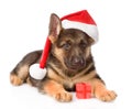 German Shepherd puppy with red hat and gift box. isolated on white Royalty Free Stock Photo