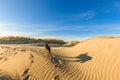 German shepherd walking on young sand dunes formed by flooding at high tides Royalty Free Stock Photo