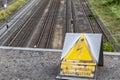 German sign caution high voltage on a bridge above tracks Royalty Free Stock Photo