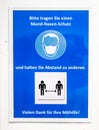 German sign during corona virus telling to wear a face mask for protection