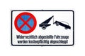 German sign isolated over white. Vehicles illegally parked will