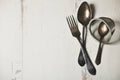 German silver spoon, fork and other utensils on a white wooden b Royalty Free Stock Photo