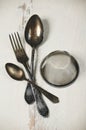 German silver spoon, fork and other utensils on a white wooden b Royalty Free Stock Photo