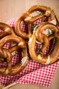 German soft Brezel pretzel with salt, chives and butter in bread basket Royalty Free Stock Photo