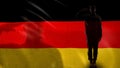 German soldier silhouette saluting against national flag, memorial day, defense Royalty Free Stock Photo
