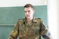 German soldier stands in a classroom