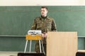 German soldier stands in a classroom