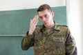 German soldier stands in a classroom