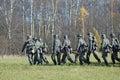 German soldiers-reenactors walk on green grass Royalty Free Stock Photo