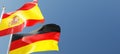 german and spanish flags waving in the wind against a blue sky mockup with copy space. germany and spain national symbols 3d