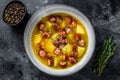 German Split pea soup with smoked sausages and meat. Black background. Top view. Copy space Royalty Free Stock Photo