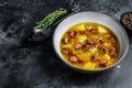 German Split pea soup with smoked sausages and meat. Black background. Top view. Copy space Royalty Free Stock Photo