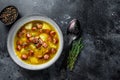 German Split pea soup with smoked sausages and meat. Black background. Top view. Copy space Royalty Free Stock Photo