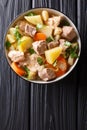 German stew Pihelsteiner with vegetables and three kinds of meat close-up in a bowl. Vertical top view Royalty Free Stock Photo