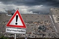 Achtung Sturmschaden german red warning sign in front of storm Royalty Free Stock Photo