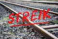 German text Streik meaning strike over rusty metal railway tracks and brackets in a ballast bed, selected focus Royalty Free Stock Photo