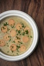 German traditional KARTOFFELSUPPE potato and sausage soup on wood table Royalty Free Stock Photo