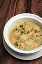 German traditional KARTOFFELSUPPE potato and sausage soup on wood table Royalty Free Stock Photo