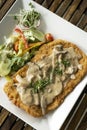 German veal Jagerschnitzel schnitzel cutlet with mushroom sauce and salad