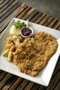 German veal schnitzel cutlet with potato and red berry sauce