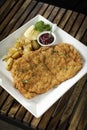 German veal schnitzel cutlet with potato and red berry sauce