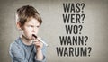 German 5W questions, what, who, where, when, why, Boy on grunge Royalty Free Stock Photo