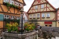 German wood framed houses and little fenced fountain at Plonlei