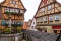 German wood framed houses and little fenced fountain at Plonlei