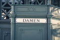 The german word `Damen` women at historic public restroom,