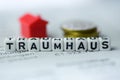 German Word DREAMHOUSE formed by alphabet blocks: TRAUMHAUS