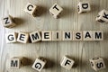German word gemeinsam from wooden blocks Royalty Free Stock Photo