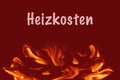 German word for heating costs on red background with fire