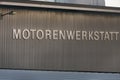 The german word `Motorenwerkstatt` in capital letters on an metal wall
