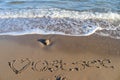 The german word Ostsee Baltic Sea and a heart written into the sand of the beach