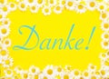 German word for Thank You on yellow background framed by daisies Royalty Free Stock Photo