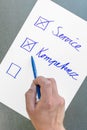 The German words service and competence on a piece of paper as core points for enterprise management Royalty Free Stock Photo