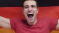 German Young Man Celebrates holding the Flag of Germany in Slow Motion