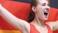 German Young Woman Celebrates holding the Flag of Germany in Slow Motion